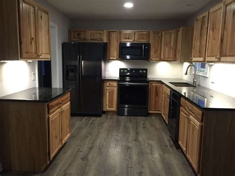 black stainless steel kitchen with wood cabinets|black stainless steel hardware.